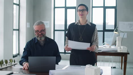 Portrait-of-Male-and-Female-Middle-Age-Architects-in-Office